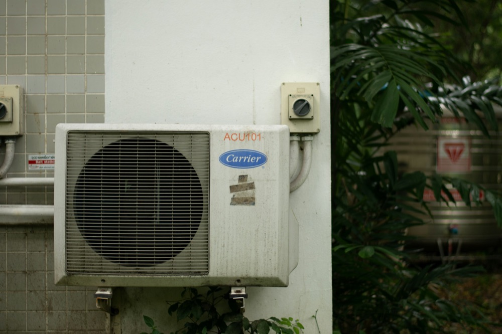 Technician servicing the controls on a geothermal heat pump unit
